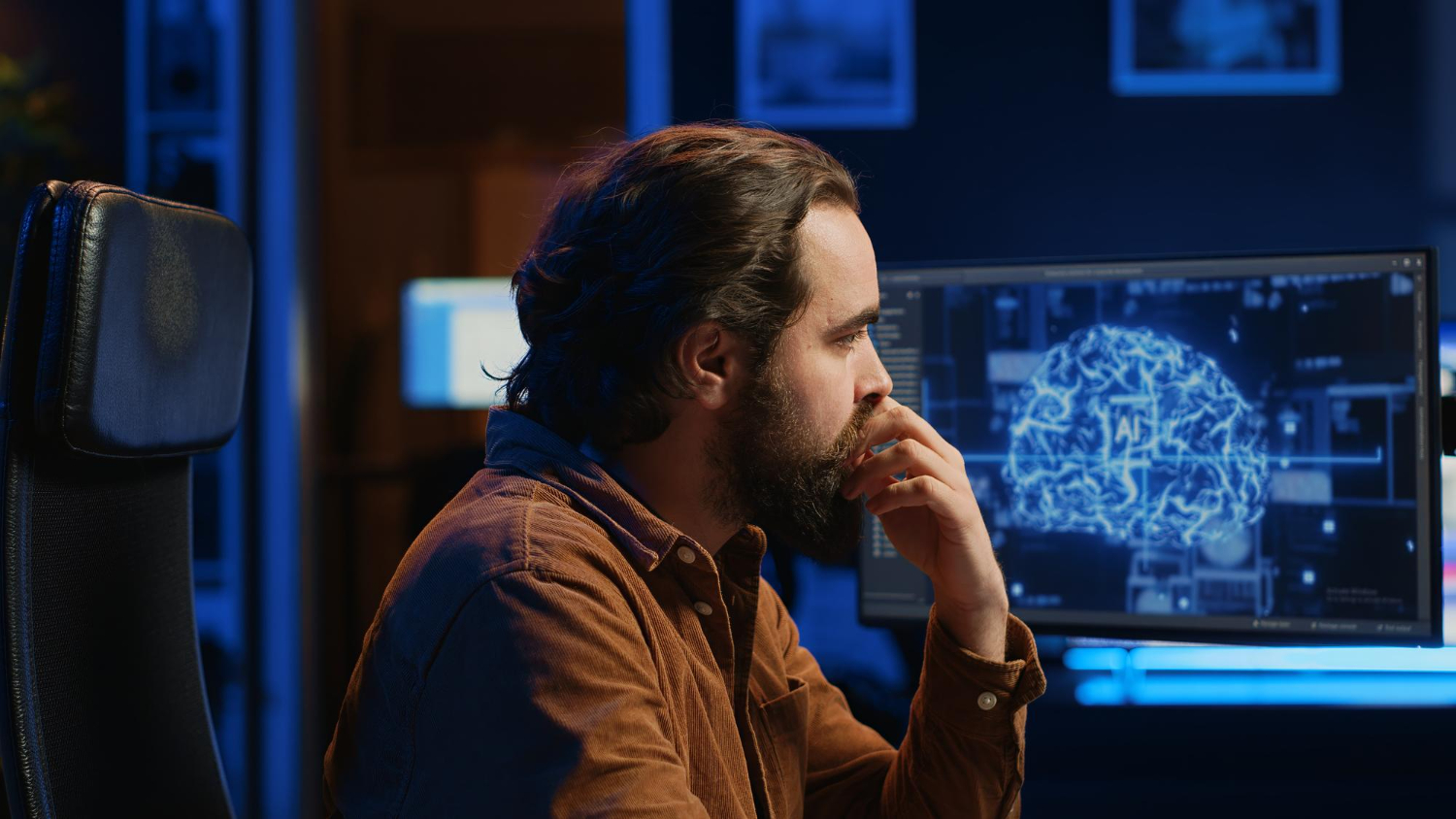 A professional reflecting in front of a screen showing an AI visualisation
